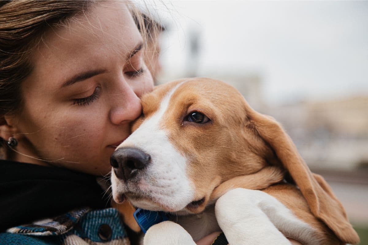 Woman Kissing Pet Dog
